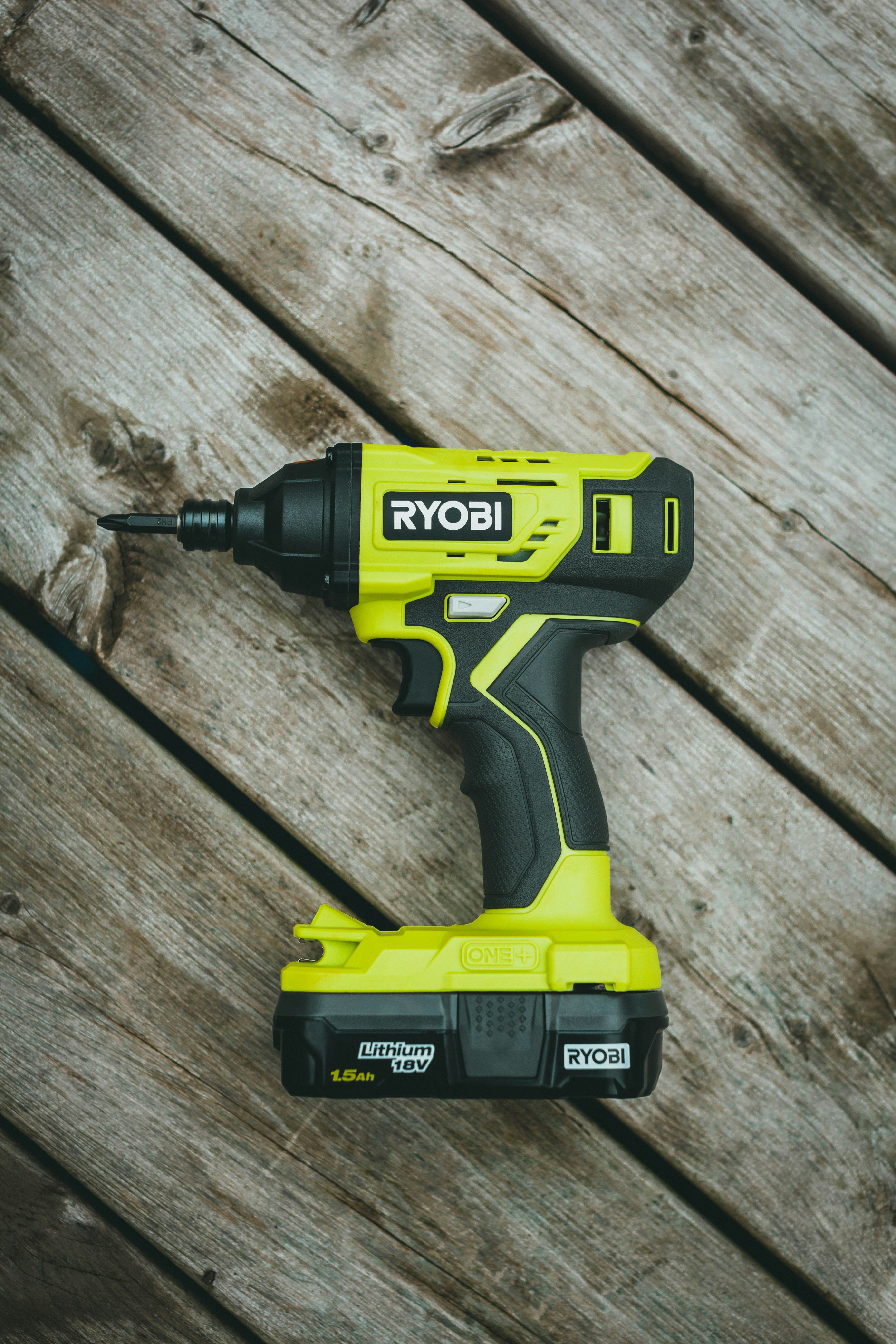 Professional contractor using both drill and impact driver on job site